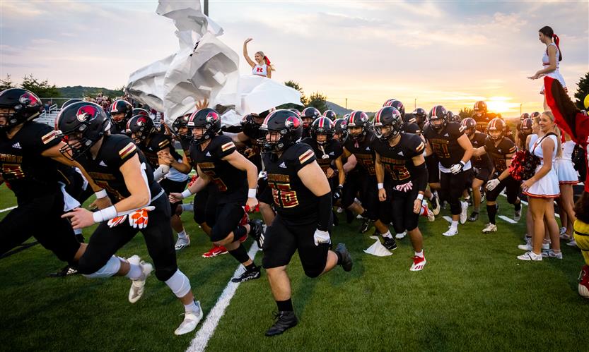 A football team runs onto the field